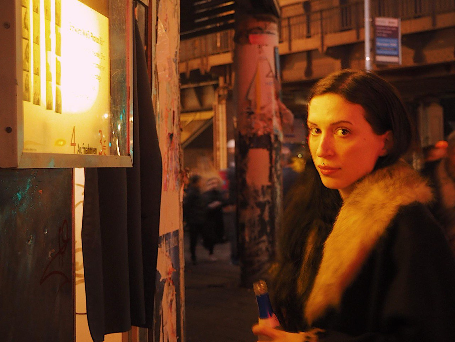 Warm, moody photo of Paša Petrović standing in the street